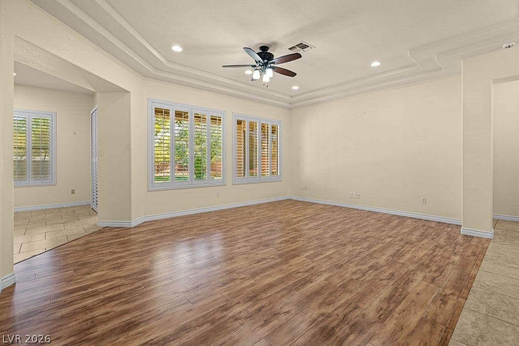 This bright room features beautiful flooring and large windows, perfect for comfortable living.