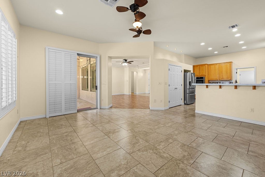 This bright interior features tiled flooring and seamless transitions between living spaces.