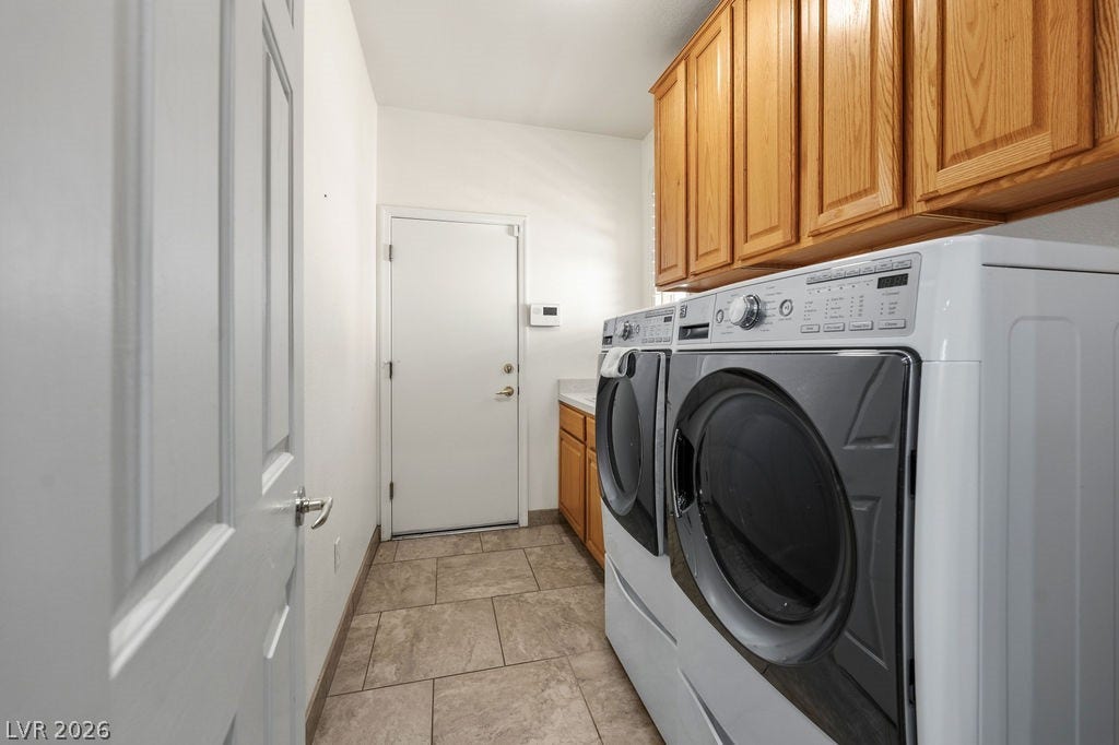 This dedicated laundry room provides convenience and ample storage for all your household needs.