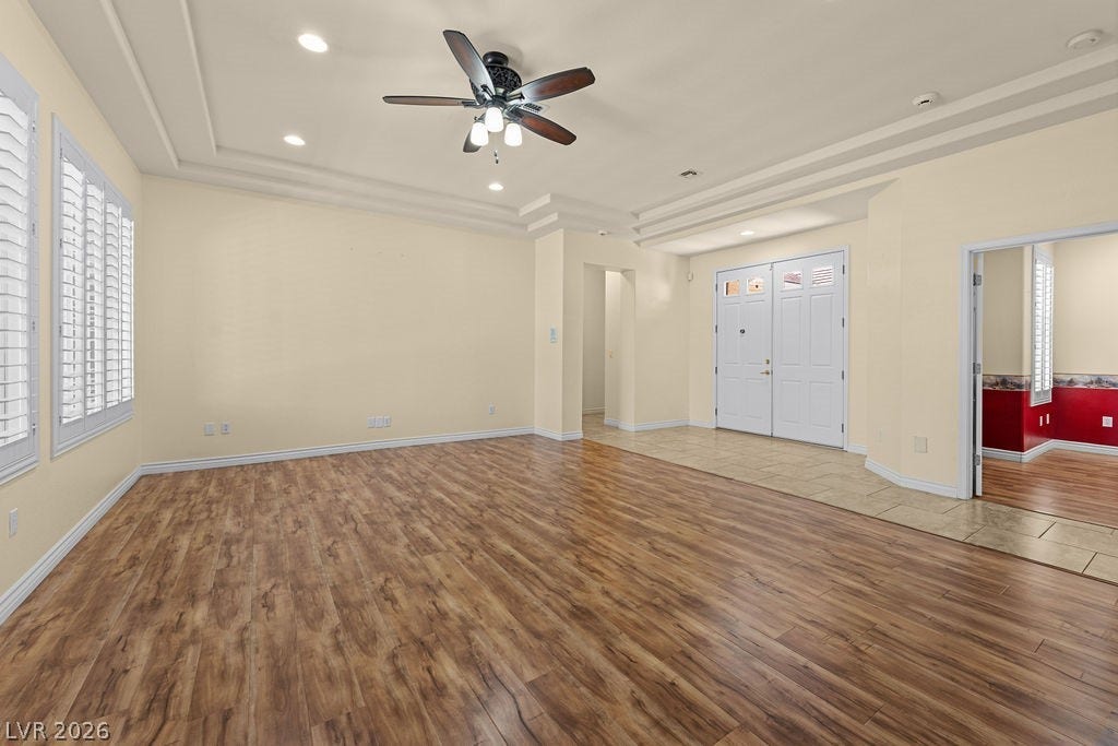 This expansive interior space features elegant wood flooring and bright natural light.