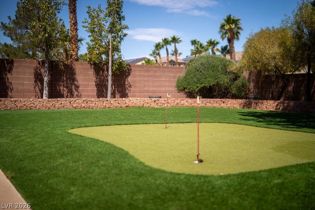 This yard features a private putting green, perfect for enjoying a round of golf at home.