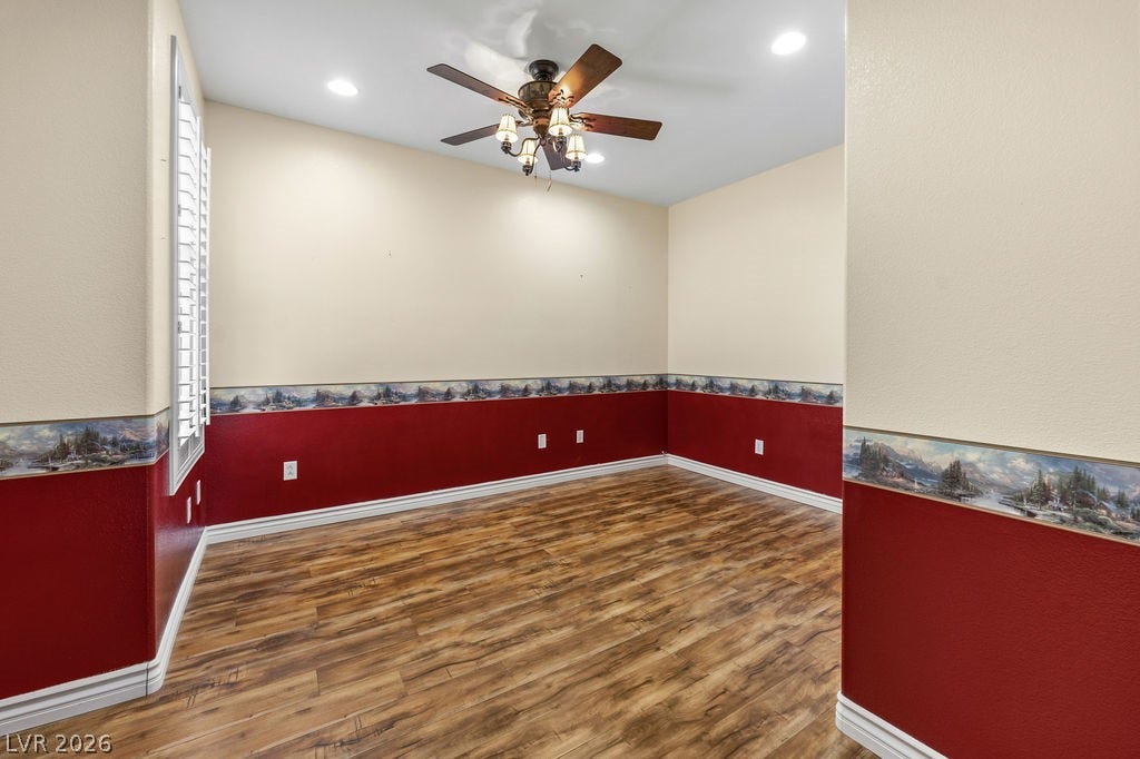 This spacious room features ample natural light and durable flooring, perfect for versatile living.
