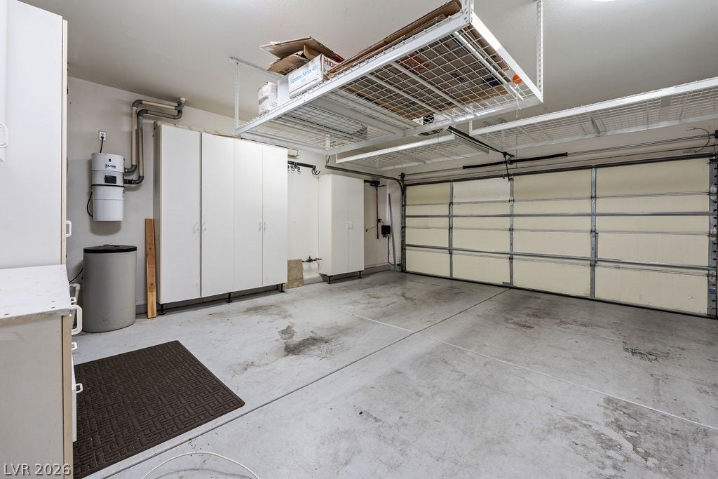 This spacious garage offers abundant storage solutions for organized living.