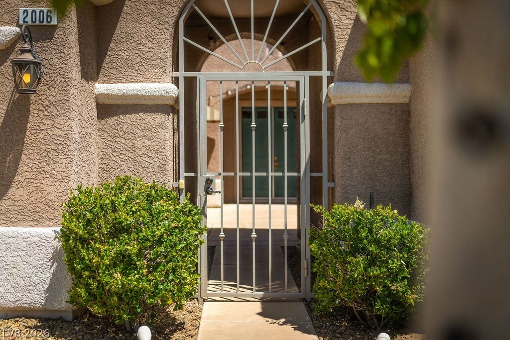 This inviting entrance features an ornamental iron gate, welcoming all who arrive.