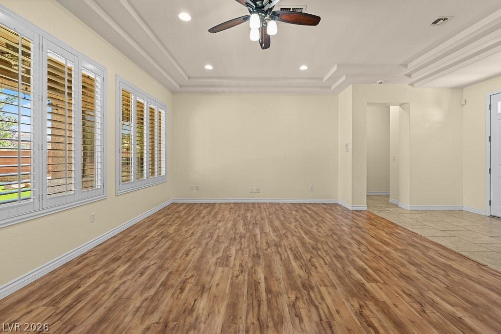 This living room features elegant wood flooring and a coffered ceiling.