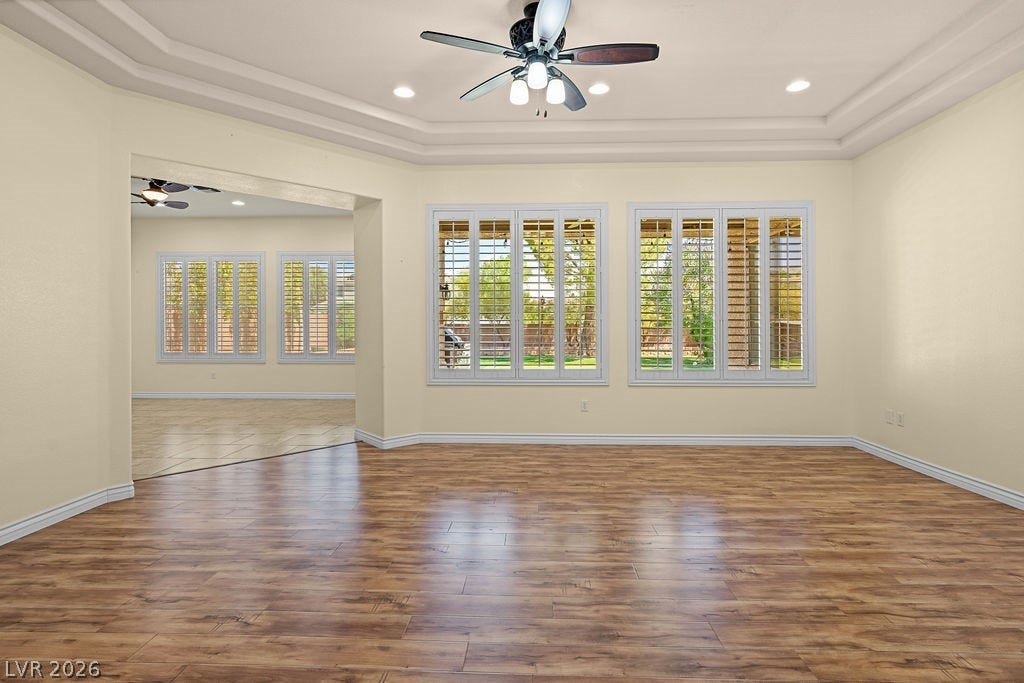 This bright room features warm wood flooring and ample natural light, creating an inviting atmosphere.