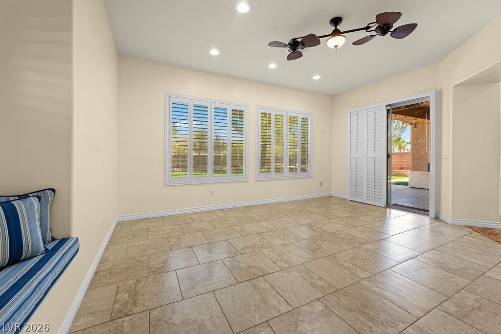 Bright, spacious room featuring tiled floors and abundant natural light.