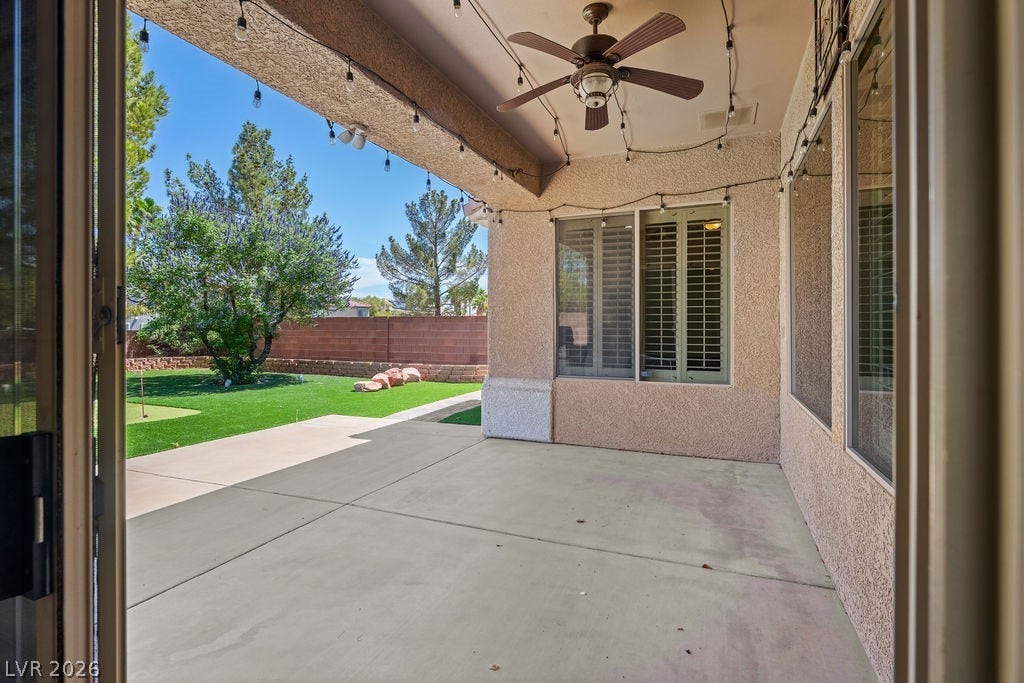 Enjoy outdoor living with a spacious patio overlooking a lush green yard.