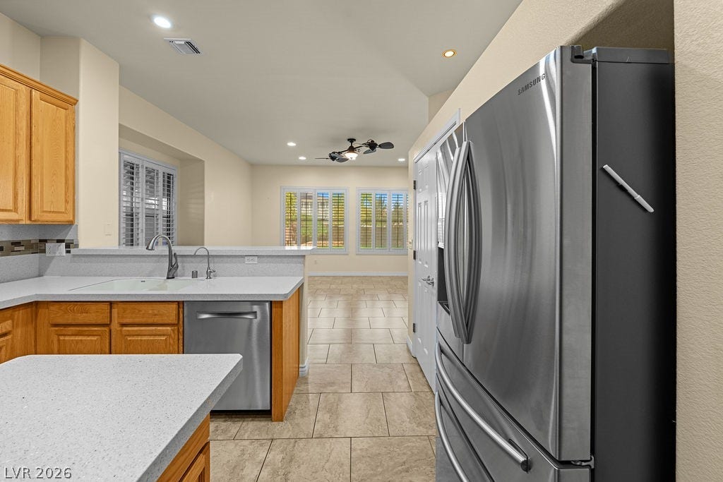 This bright kitchen features modern appliances and a functional layout, perfect for daily living and entertaining.