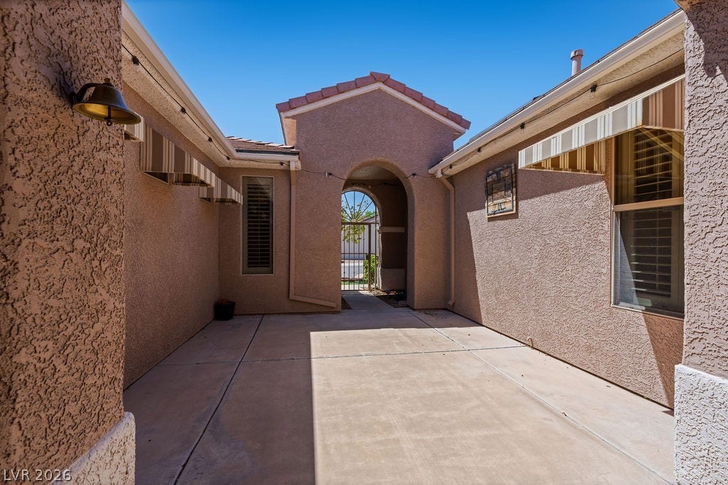 This private courtyard entry welcomes you with architectural charm and inviting outdoor space.