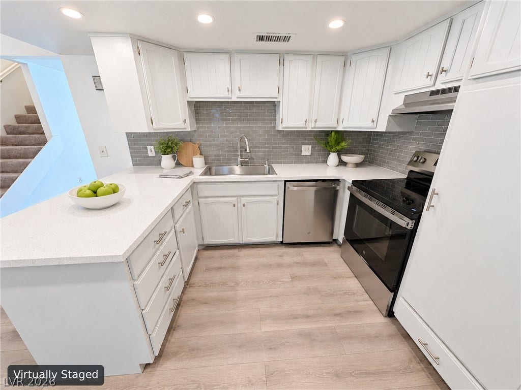 3708 Heritage Avenue, Las Vegas, NV 89121 An open kitchen layout features sleek countertops and modern stainless steel appliances.