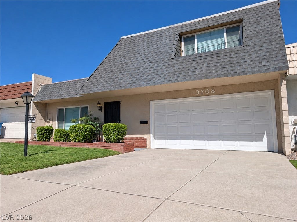 3708 Heritage Avenue, Las Vegas, NV 89121 Distinctive architectural lines and a spacious driveway define this unique multi-level home exterior.