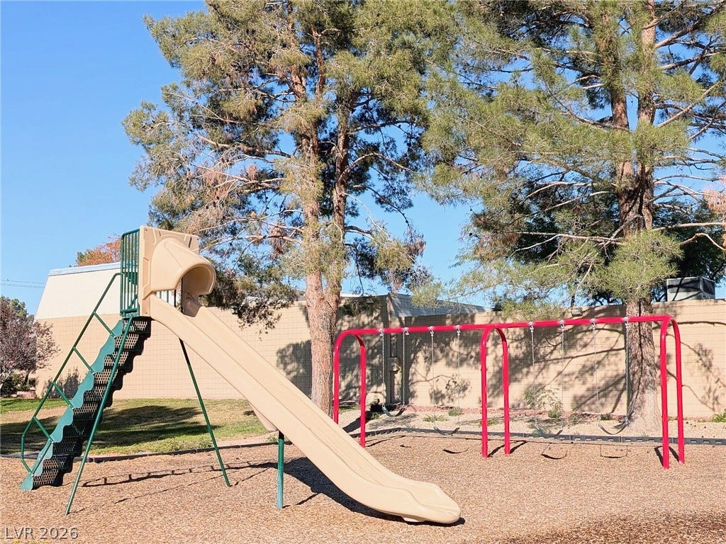 3708 Heritage Avenue, Las Vegas, NV 89121 Mature trees shade a community play area complete with swings and a slide.