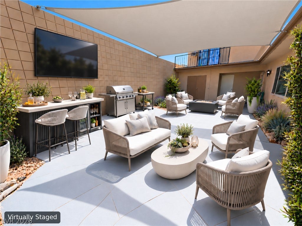 3708 Heritage Avenue, Las Vegas, NV 89121 An inviting courtyard features durable concrete flooring, tall privacy walls, and integrated lighting placements.