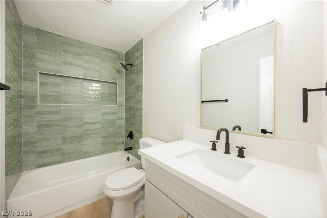 223 W Basic Road, Henderson, NV 89015 A stylish vanity paired with a beautifully tiled tub shower creates a modern design.