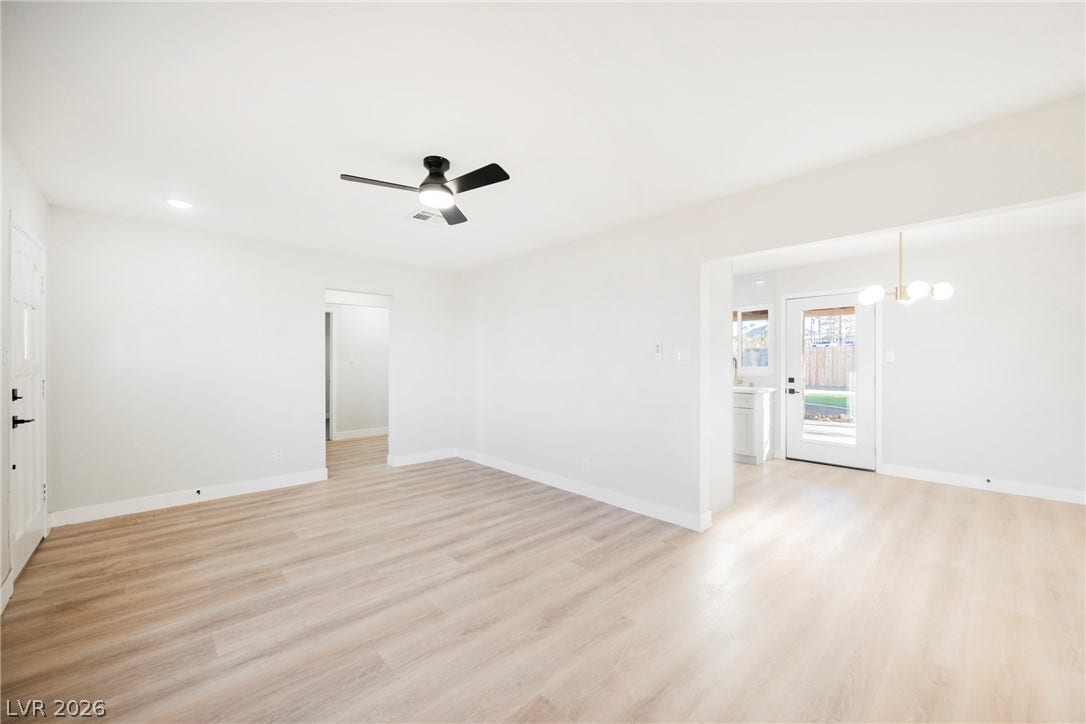 223 W Basic Road, Henderson, NV 89015 Smooth wood-look flooring anchors this open living space with clean transitions to the dining area.
