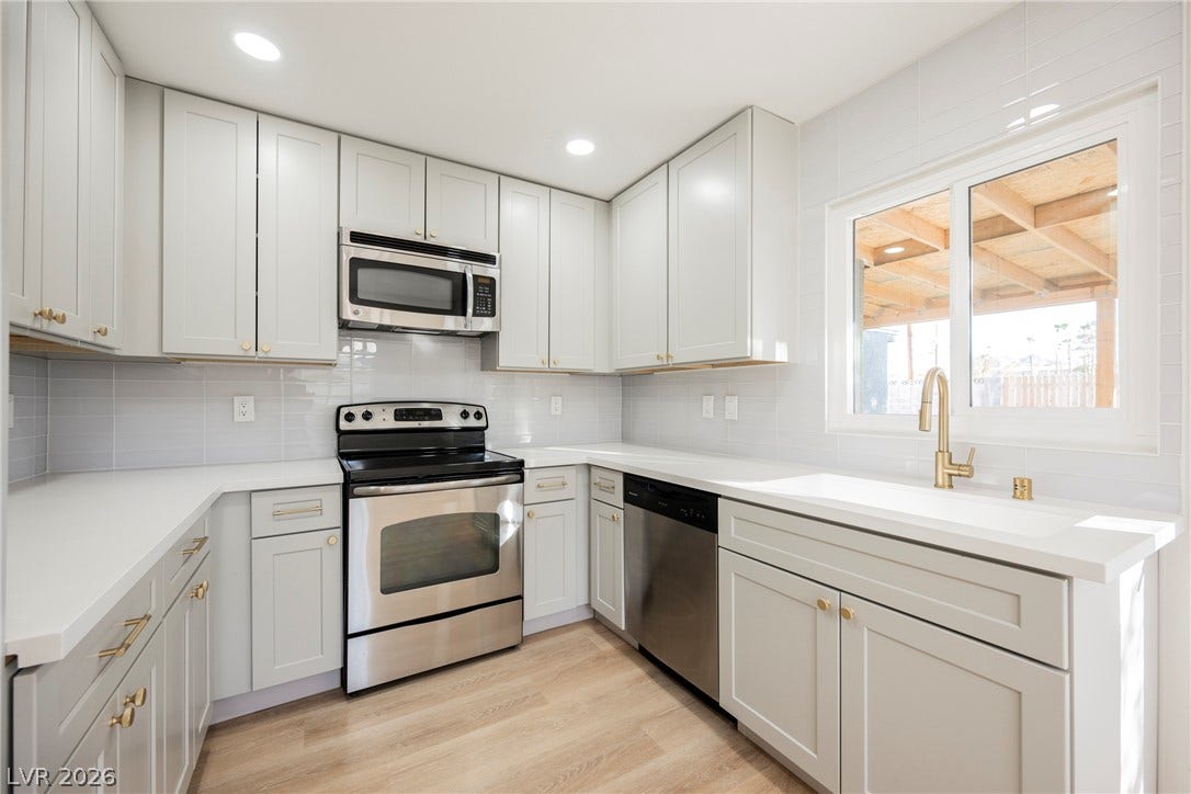 223 W Basic Road, Henderson, NV 89015 Streamlined cabinetry and modern appliances define this efficiently designed kitchen workspace.