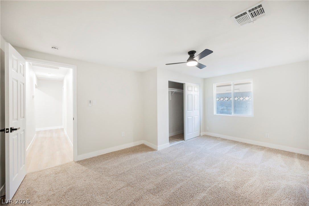223 W Basic Road, Henderson, NV 89015 Plush carpeting and a built-in closet define this comfortable secondary bedroom space.