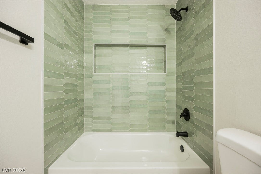 223 W Basic Road, Henderson, NV 89015 Glistening tilework and modern fixtures define this beautifully updated bath space.