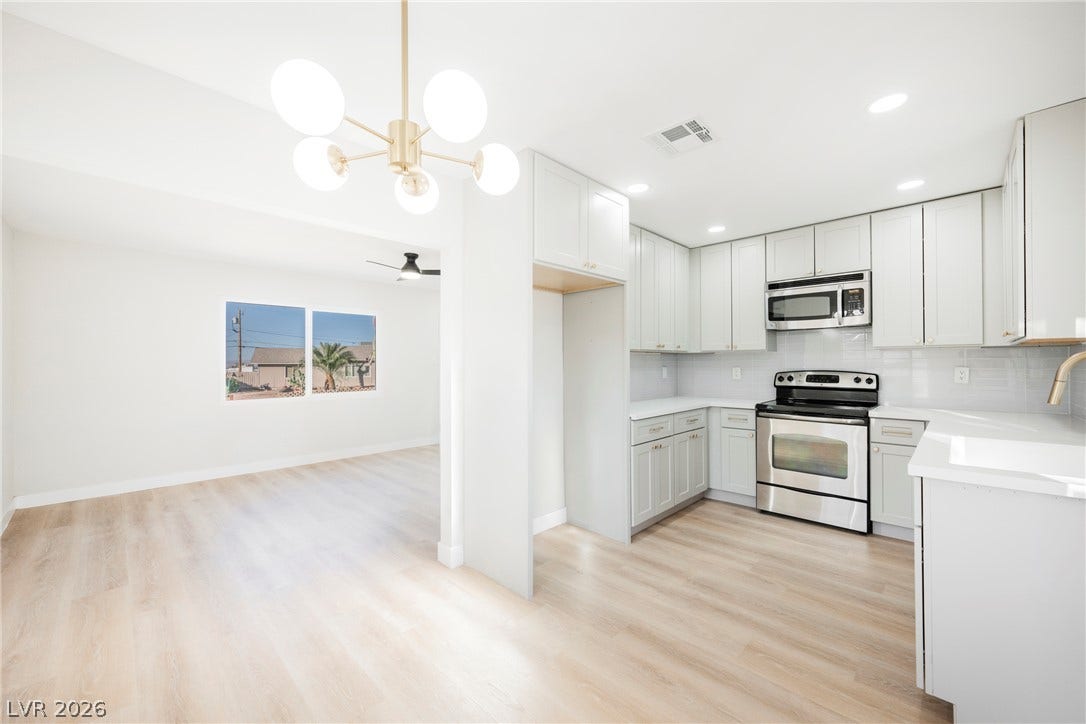 223 W Basic Road, Henderson, NV 89015 Gleaming wood floors connect the modern kitchen seamlessly to an open dining area.