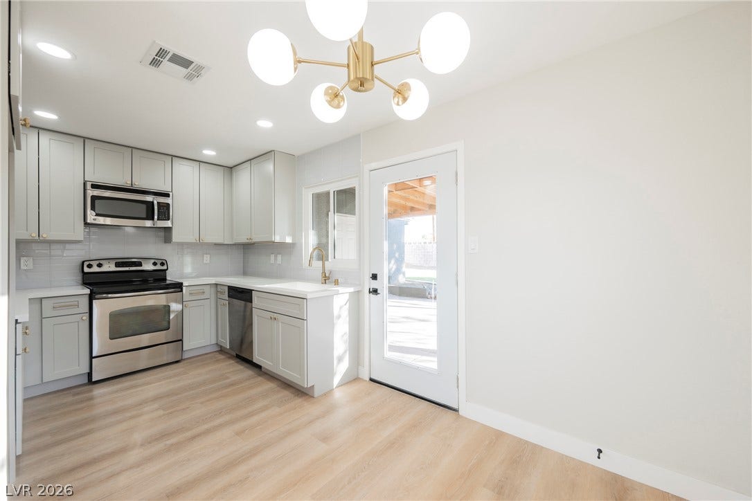 223 W Basic Road, Henderson, NV 89015 A glass exterior door opens to the patio from this updated kitchen and dining space.