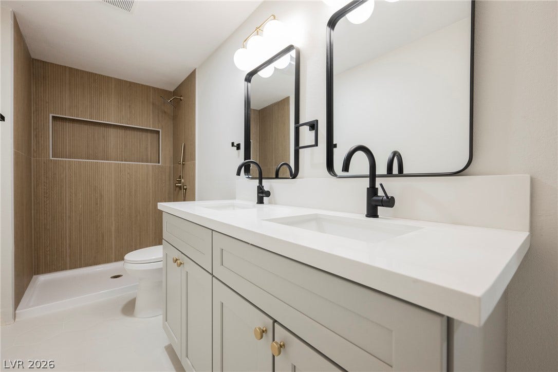 223 W Basic Road, Henderson, NV 89015 A spacious double vanity and a beautifully tiled walk-in shower highlight this modern bathroom.