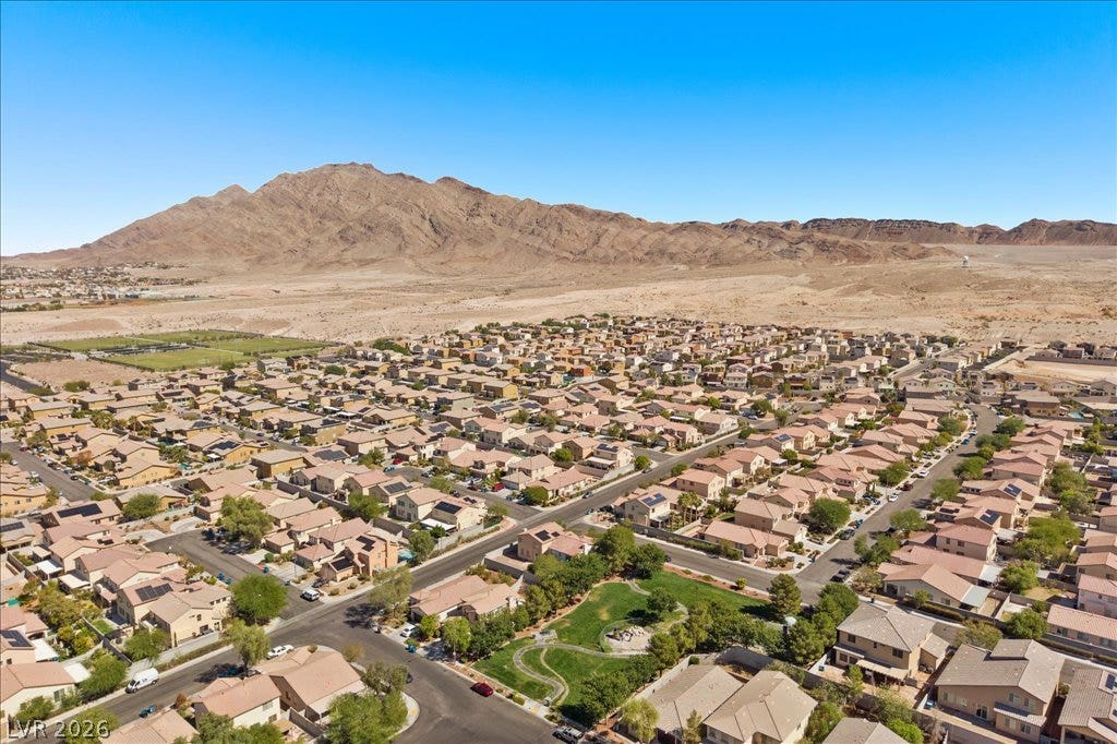 Rugged mountains form a dramatic backdrop for this established suburban neighborhood.