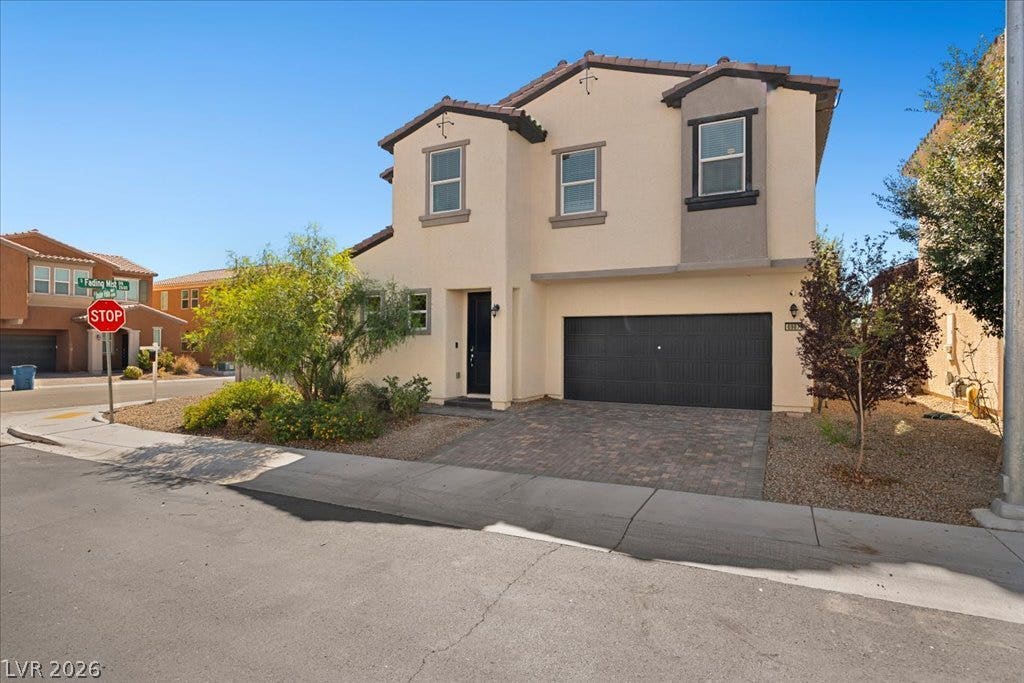 An inviting stucco exterior and paved driveway welcome you to this elegant two-story residence.
