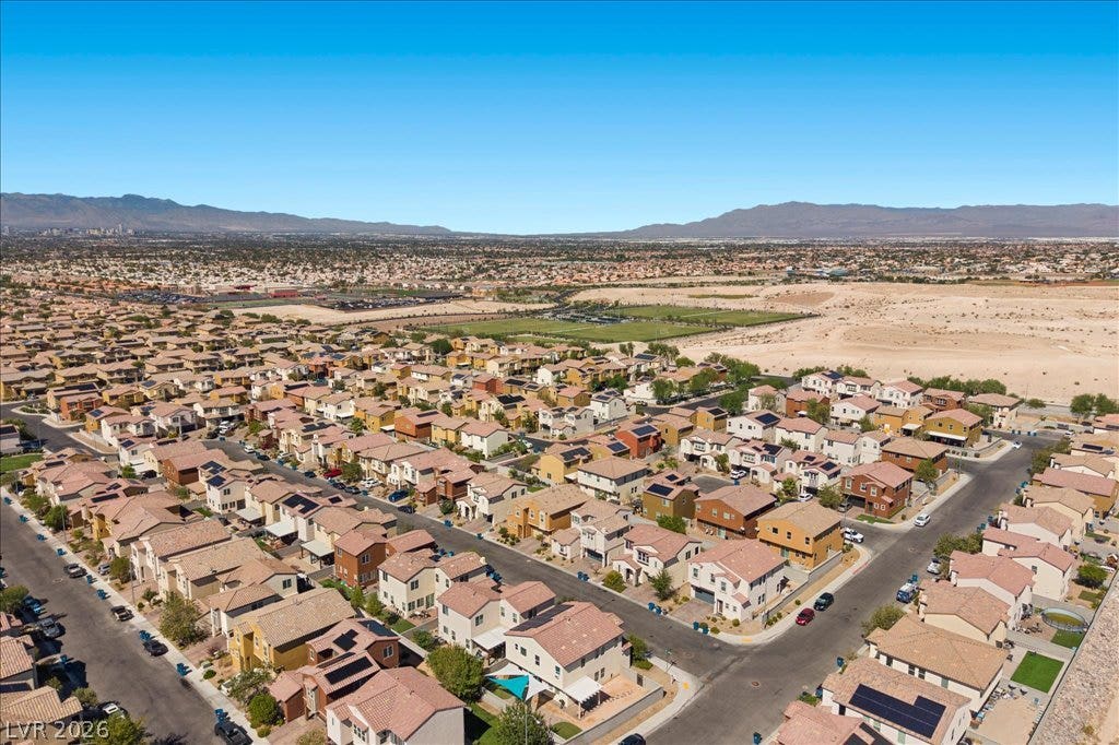 Vast desert mountain vistas frame this peaceful suburban neighborhood scene.