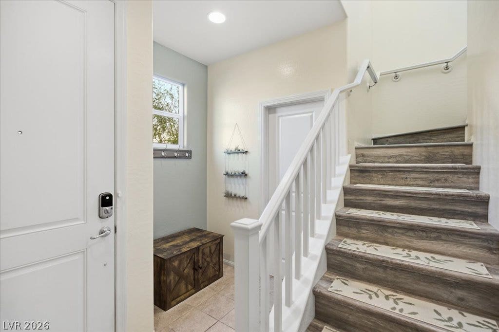 An inviting entryway with valet hooks offer organization to your lifestyle.