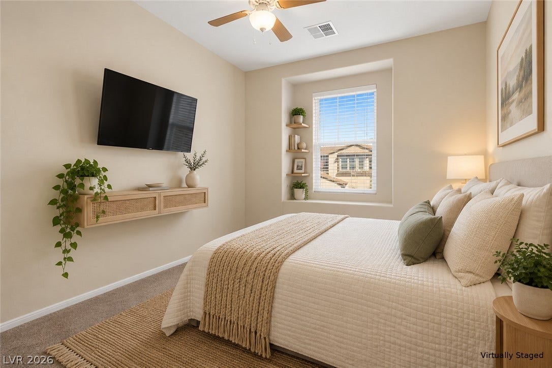 A deep window alcove and soft carpeting define this inviting secondary bedroom.