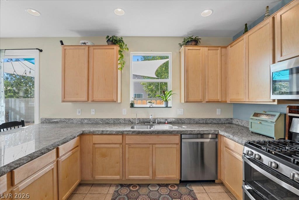 Natural wood cabinetry pairs with durable 3" granite stone countertops in a classic U-shaped workspace.