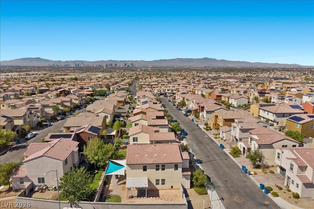 Distant mountains frame a sweeping aerial vista of this established suburban neighborhood.