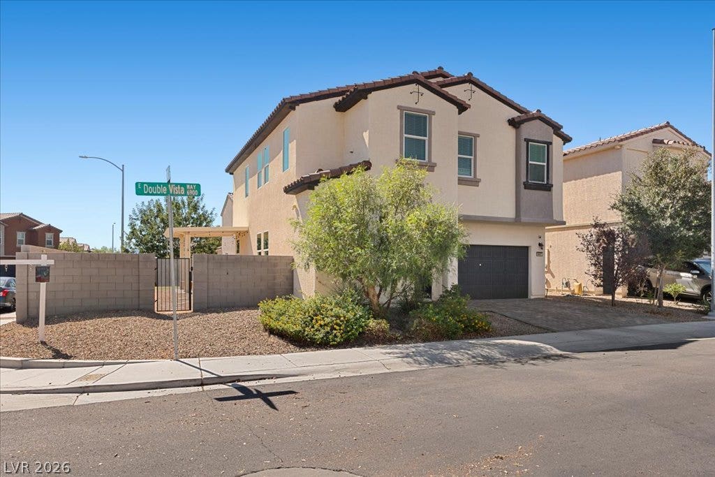 A spacious two-story exterior showcases stucco walls, tile roofing, and a private corner lot presence.