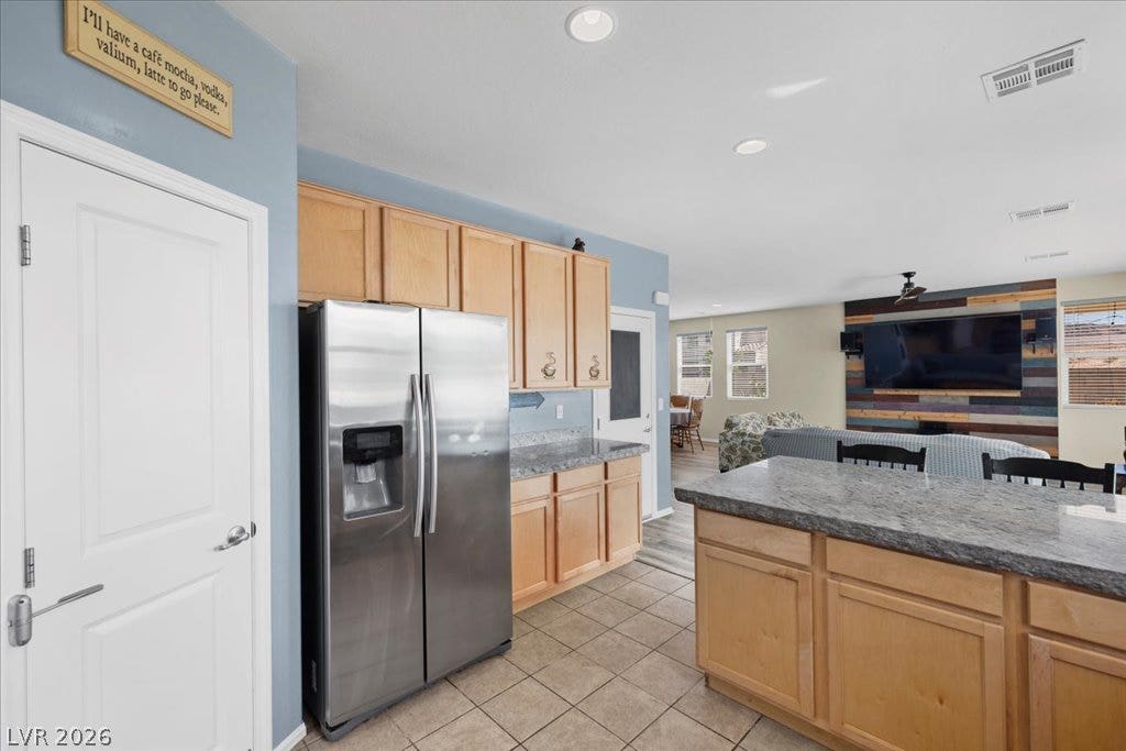 Granite countertops, Stainless steel appliances, and 42" cabinet cabinetry define this kitchen, seamlessly connecting to the open concept living space.