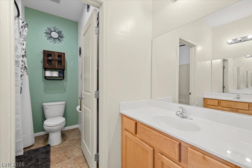 A spacious vanity mirror reflects the clean, neutral lines of this functional bathroom space.