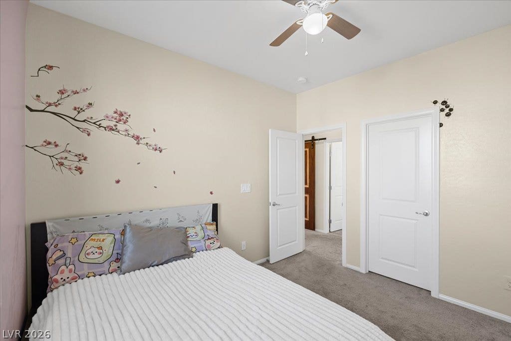 Smooth carpeting pairs with neutral walls in this comfortable bedroom space.