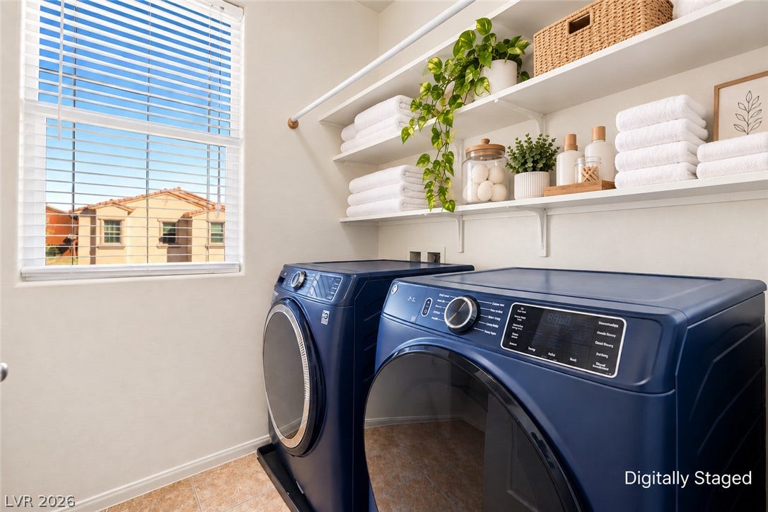 Functional laundry space includes built-in shelving and a large window looking outward. Washer and Dryer included.