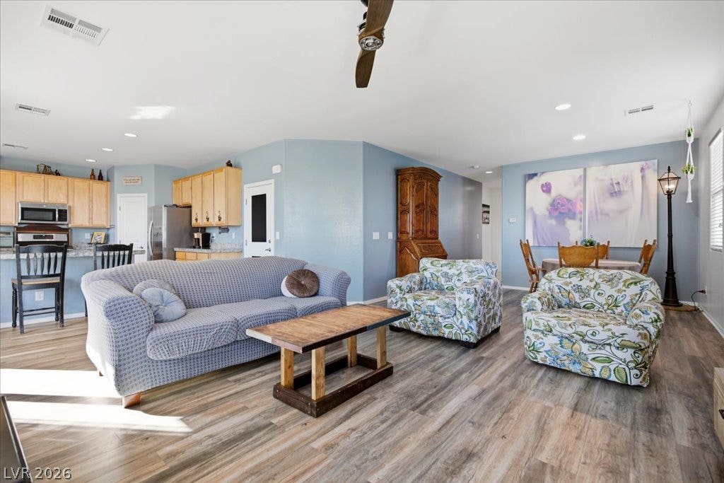 New flooring (2026) complements an open living area connected directly to the kitchen.