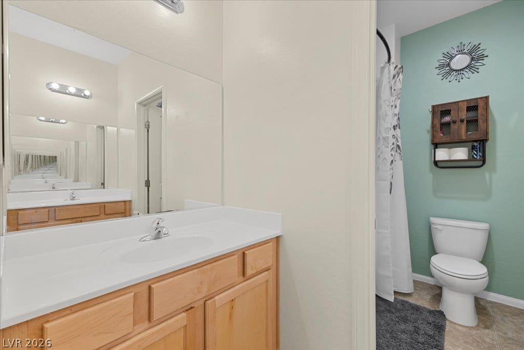 An inviting bathroom displays a classic wooden vanity set against modern neutral walls.