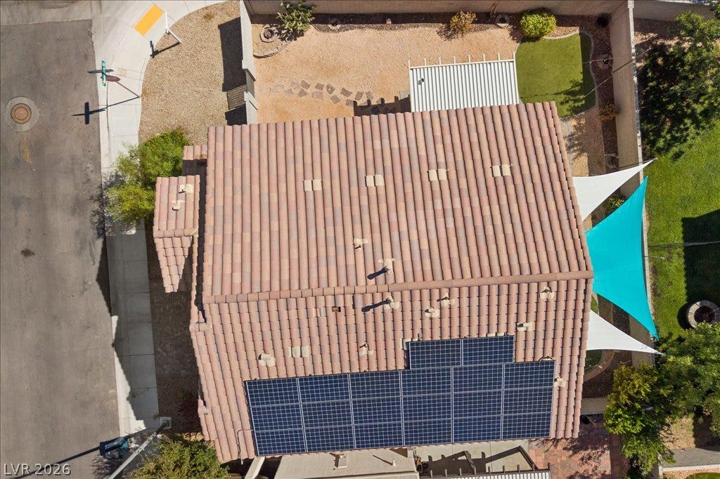 An aerial perspective showcases fully paid off Solar Panels atop a durable tile roof.