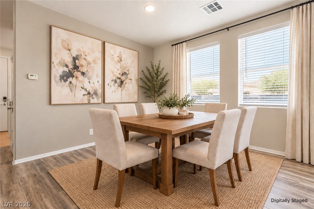 Dine in style. Warm wood flooring and natural light through large windows define this welcoming dining area.