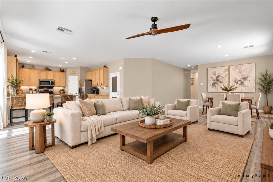 An open floorplan seamlessly connects the comfortable living area directly into the functional kitchen space. Digitally staged with furniture. Bones of the home kept as is.