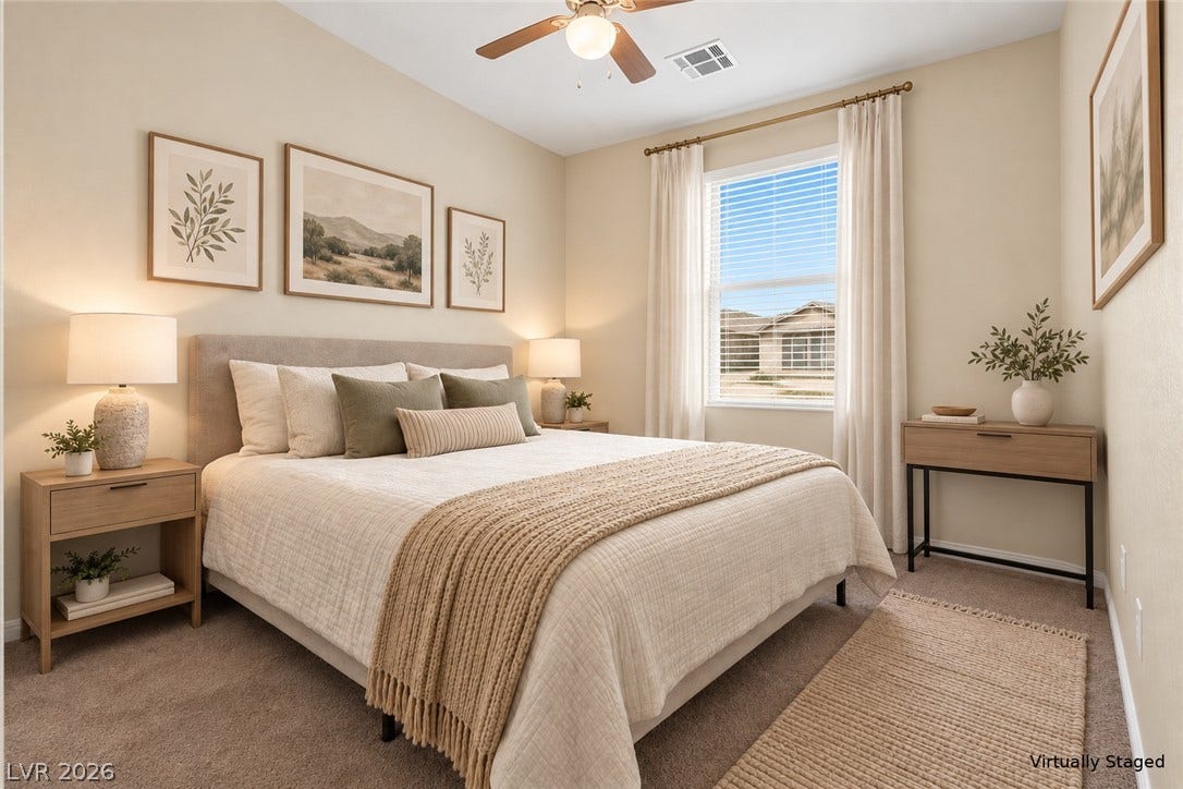 A single window draws natural light across the neutral walls and soft carpeting.