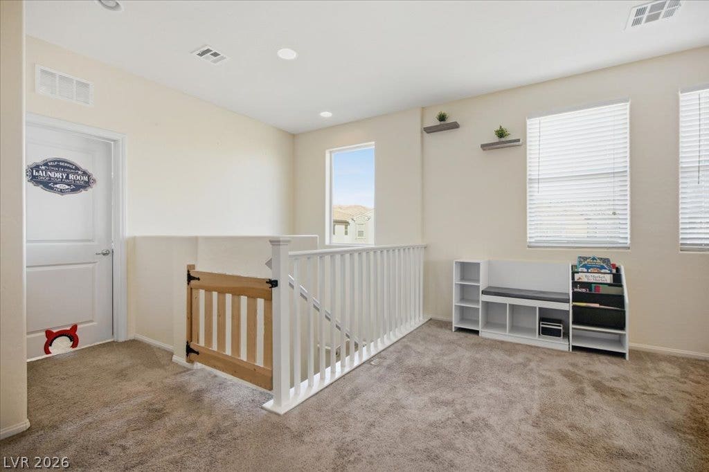 A spacious carpeted landing upstairs provides versatile extra living space with bright natural light.