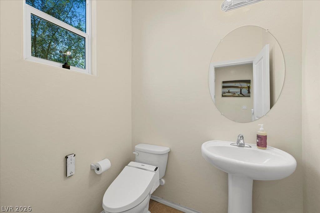 A classic pedestal sink paired with a heated toilet seat step up your standard half-bathroom setup.