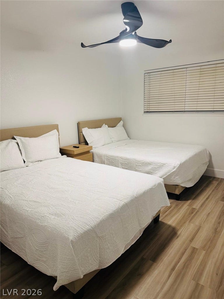 Smooth wood-plank flooring underfoot complements the minimalist design of this peaceful sleeping space.