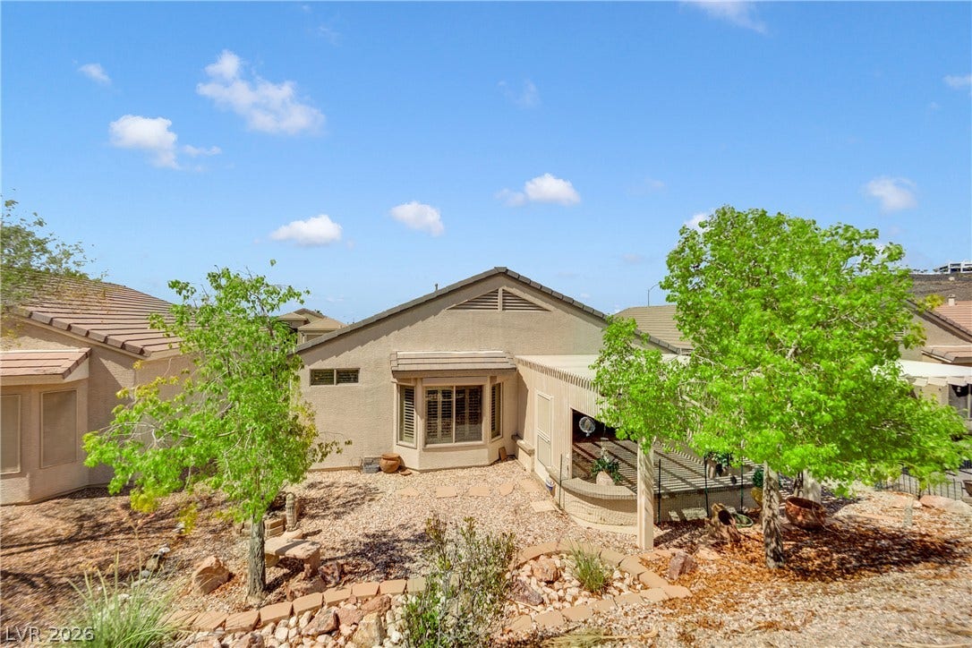 1811 Tiger Creek Avenue, Henderson, NV 89012 Fully landscaped backyard with mature shade trees, terraced rock accents, and low-maintenance desert design enjoy the outdoors without the upkeep