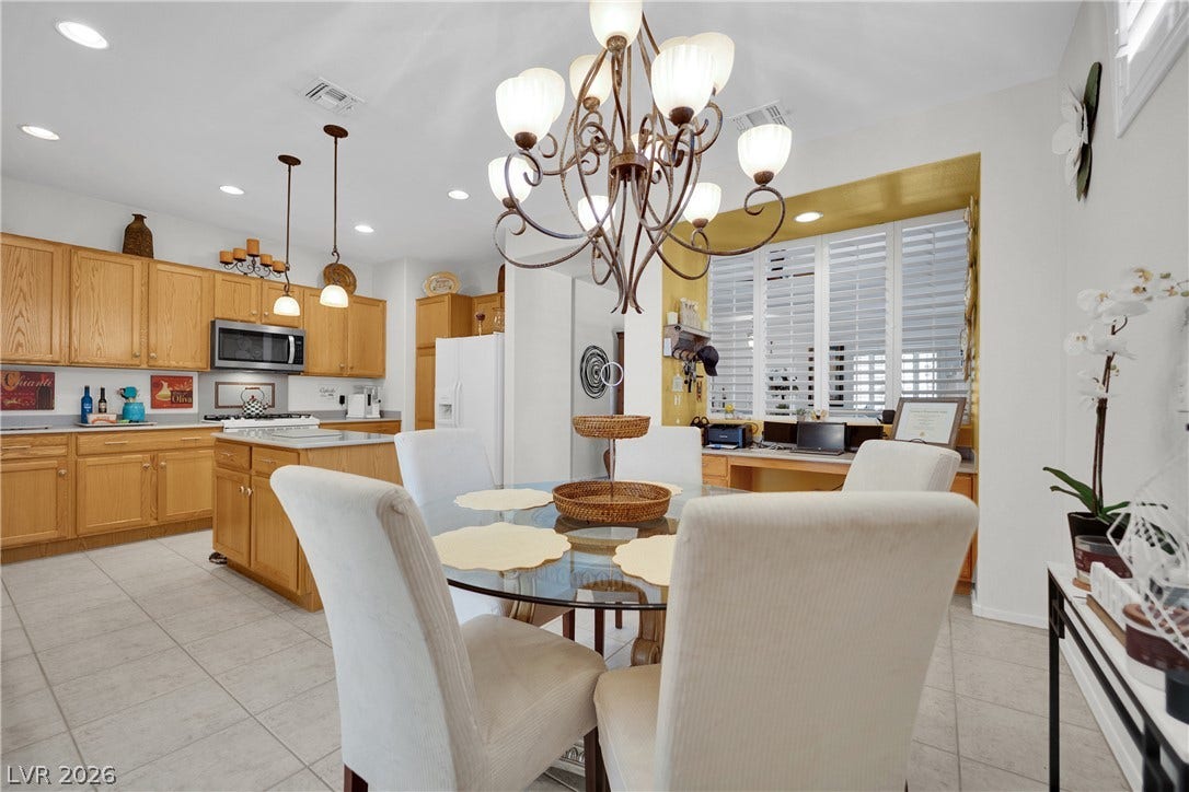 1811 Tiger Creek Avenue, Henderson, NV 89012 The heart of the home a center island kitchen opens to a sunlit dining area and built-in desk nook, blending everyday convenience with entertaining-ready flow.
