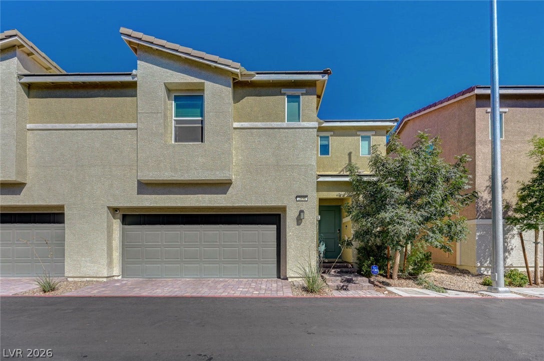 Modern multi-level exterior displays clean stucco finishes, paved driveways, and geometric rooflines.